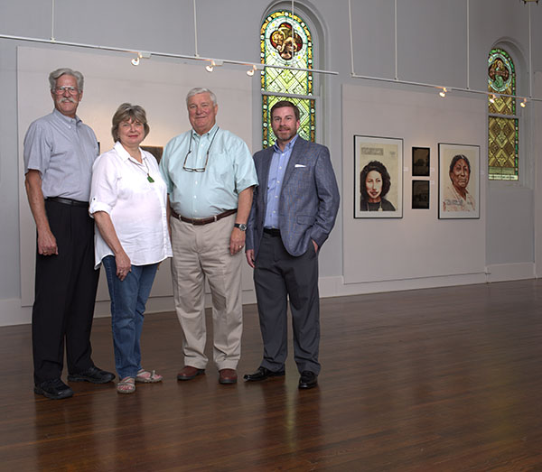 group of people standing in art gallery